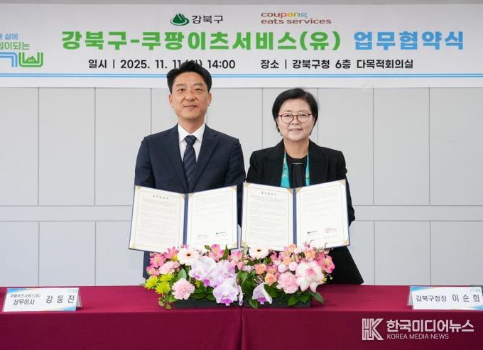 이순희 강북구청장(오른쪽)과 강동진 쿠팡이츠서비스 상무이사가 11일 강북구청 다목적회의실에서 업무협약을 체결한 뒤 협약서를 들어 보이고 있다.